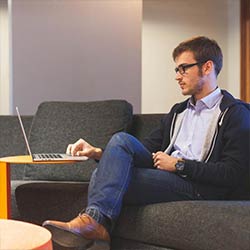 The image of a man as a client working on a laptop