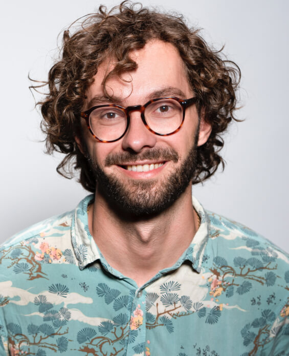 a smiling man having long hair